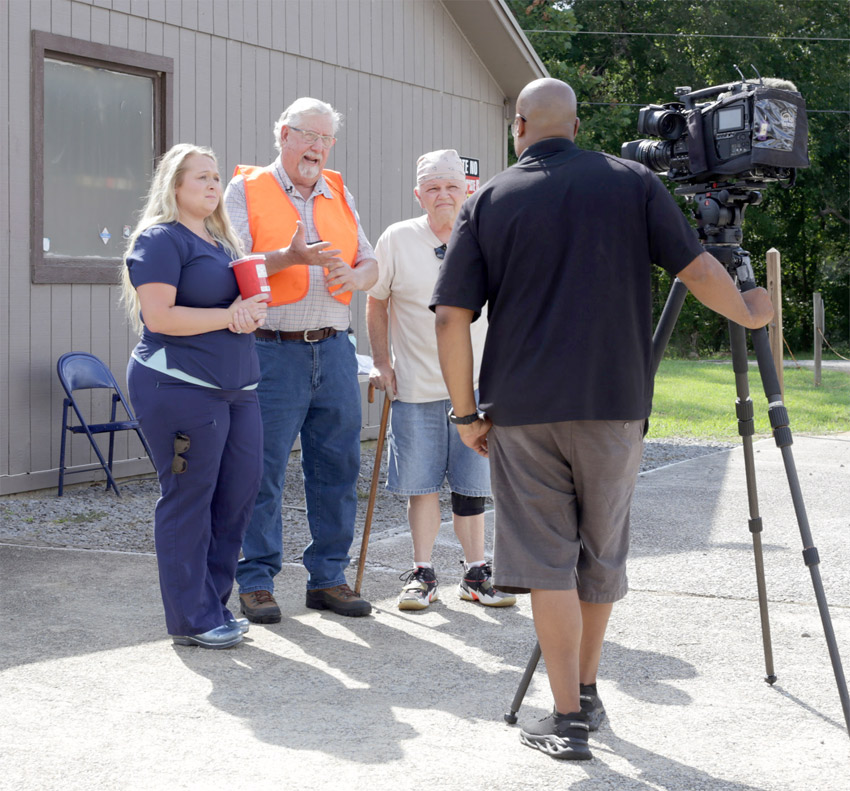 At an Aug. 22 public awareness event, Remlap residents Hope Minyard, Ray C. Morton, Jr., and Michael Wesson speak on camera for ABC3340 News about the proposed medical waste facility. Photo by Kristin Yarbrough.