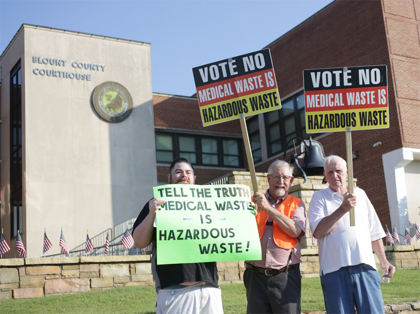 Shane Ledbetter, Ray C. Morton, Jr., and George Thomason protest the proposed medical waste facility the morning of the Sept. 4 public hearing. Photo by Kristin Yarbrough.
